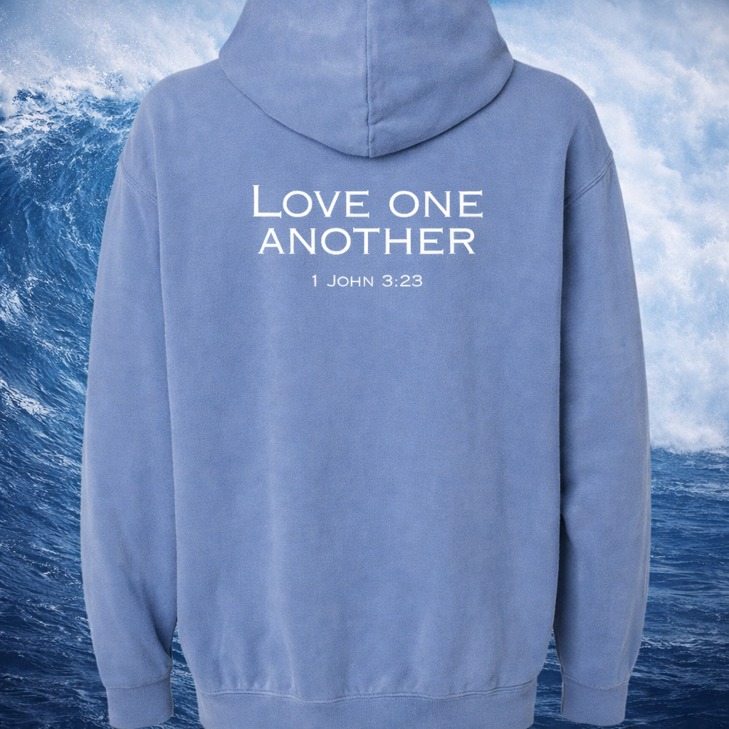 Blue hoodie with a Christian graphic and text on the back, set against a beach background.