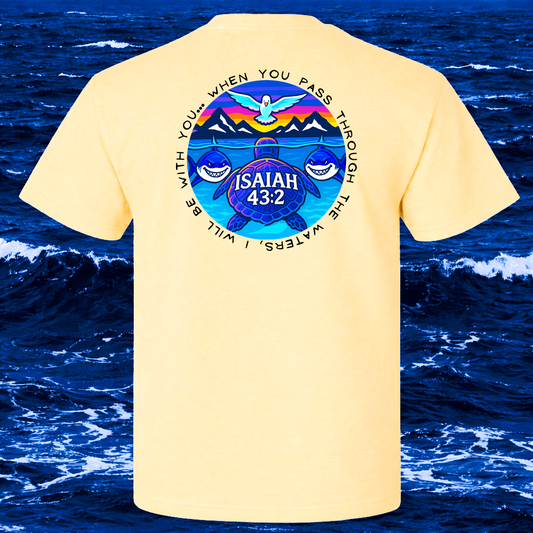 Beige t-shirt with a Christian graphic design on the back against a blue ocean background