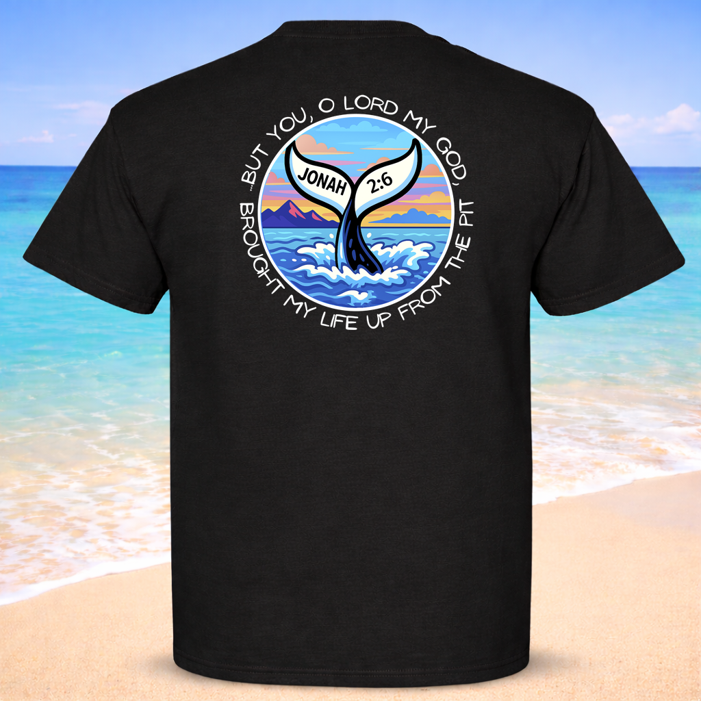 Black t-shirt with a whale and ocean design on the back, set against a beach background.