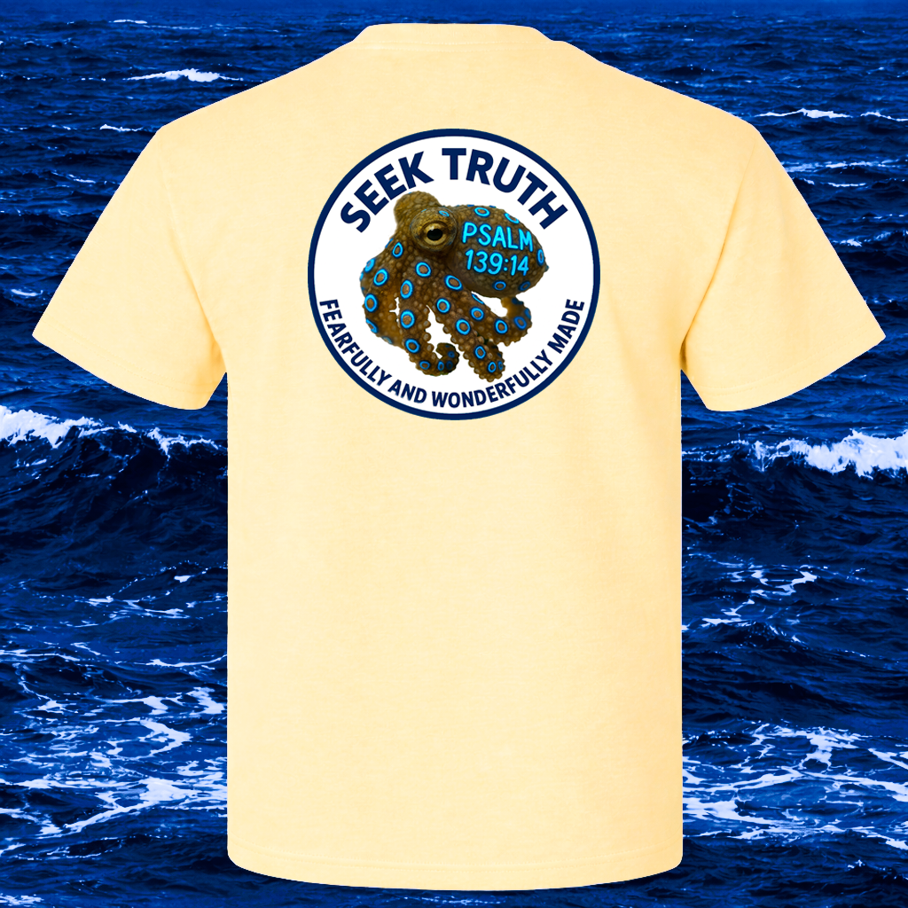 Yellow t-shirt with a Blue Ringed Octopus graphic and text on the back, set against a beach background.