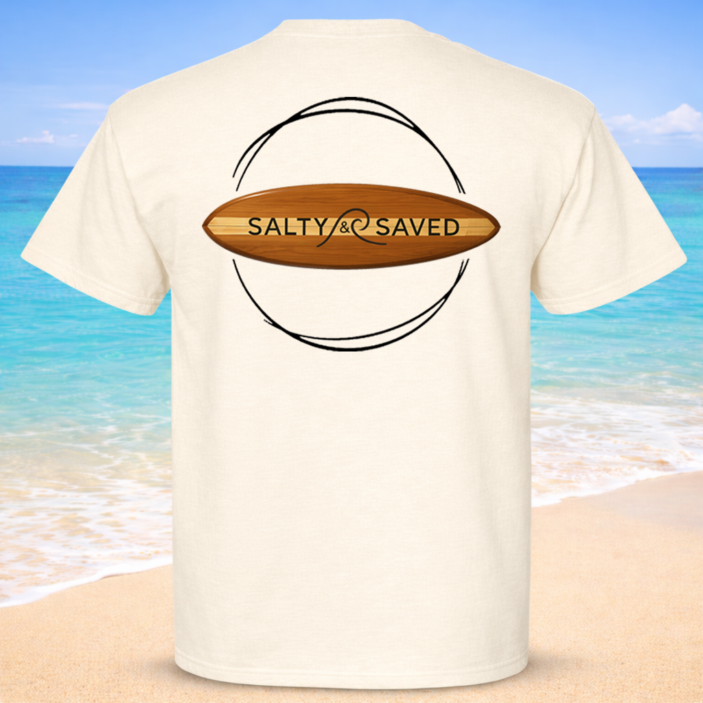 White t-shirt with 'Salty & Saved' design on a beach background