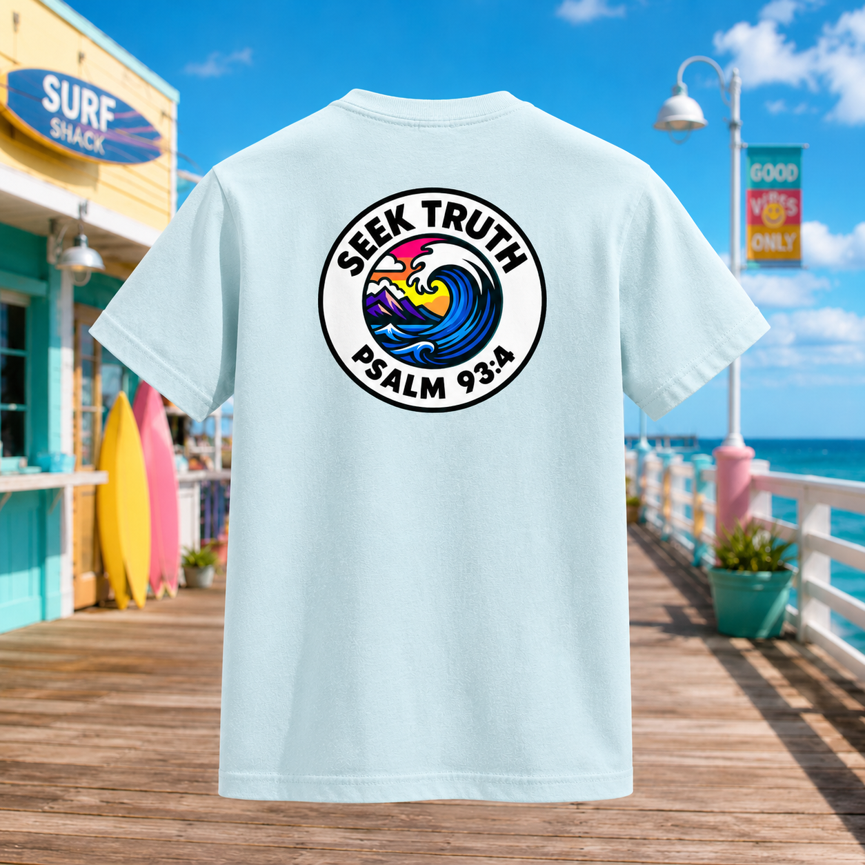 Light blue t-shirt with 'Seek Truth Psalm 93:4' design on a beachside boardwalk.