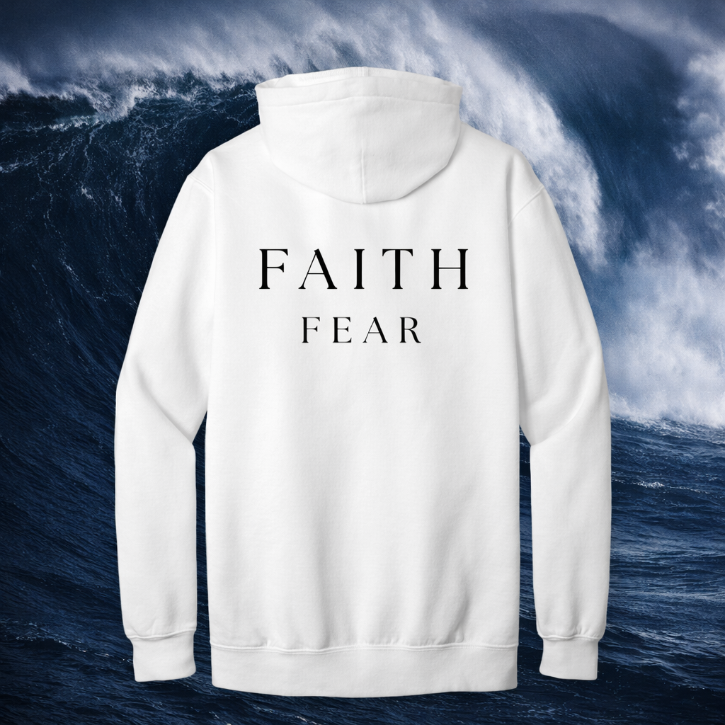 White hoodie with 'FAITH FEAR' text on the back against a stormy ocean background