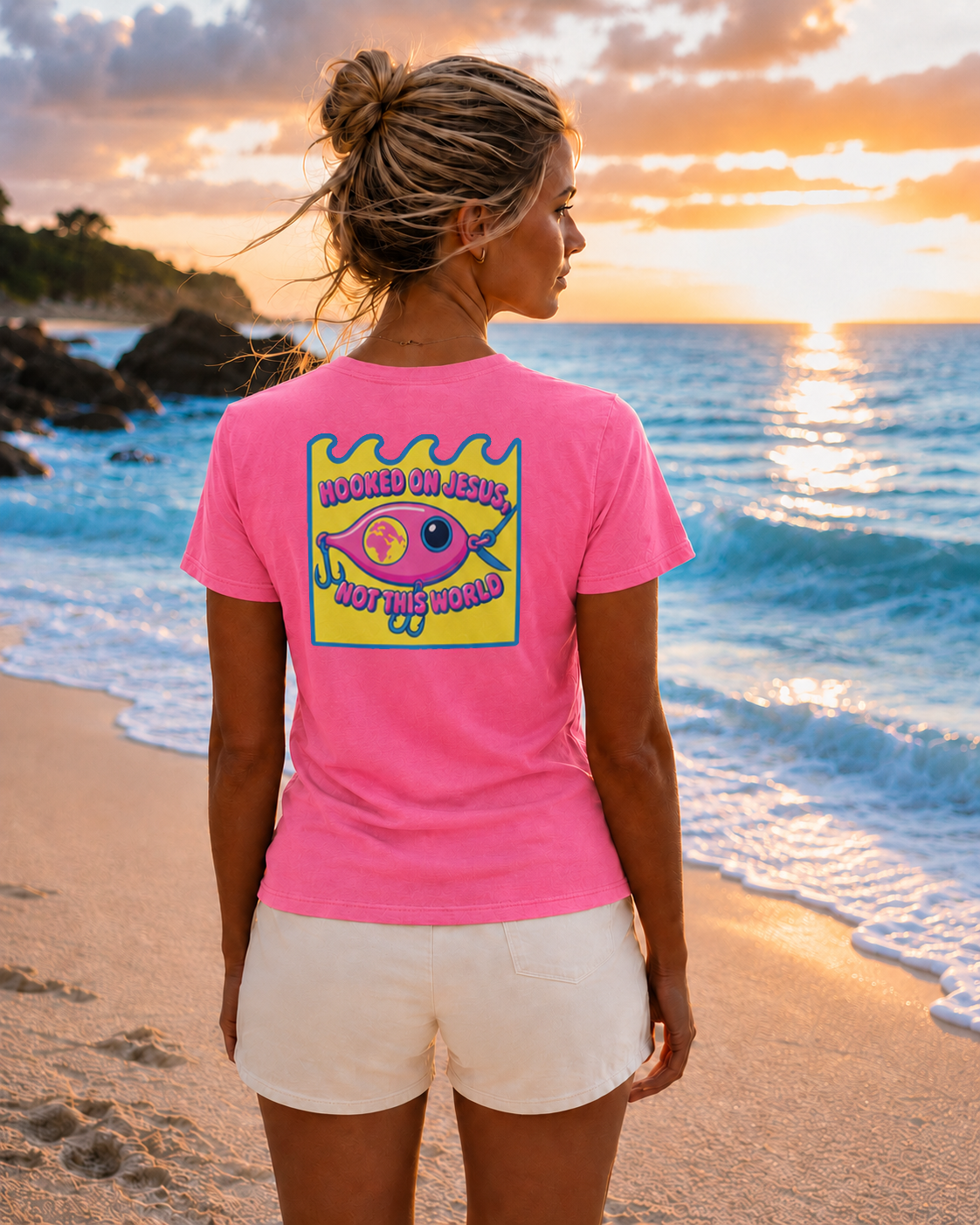 Female model wearing a Neon Pink Comfort Colors 1717 T-shirt featuring the Pink Fishing Lure Hooked on Jesus coastal Christian graphic by Seek Truth Graphics.