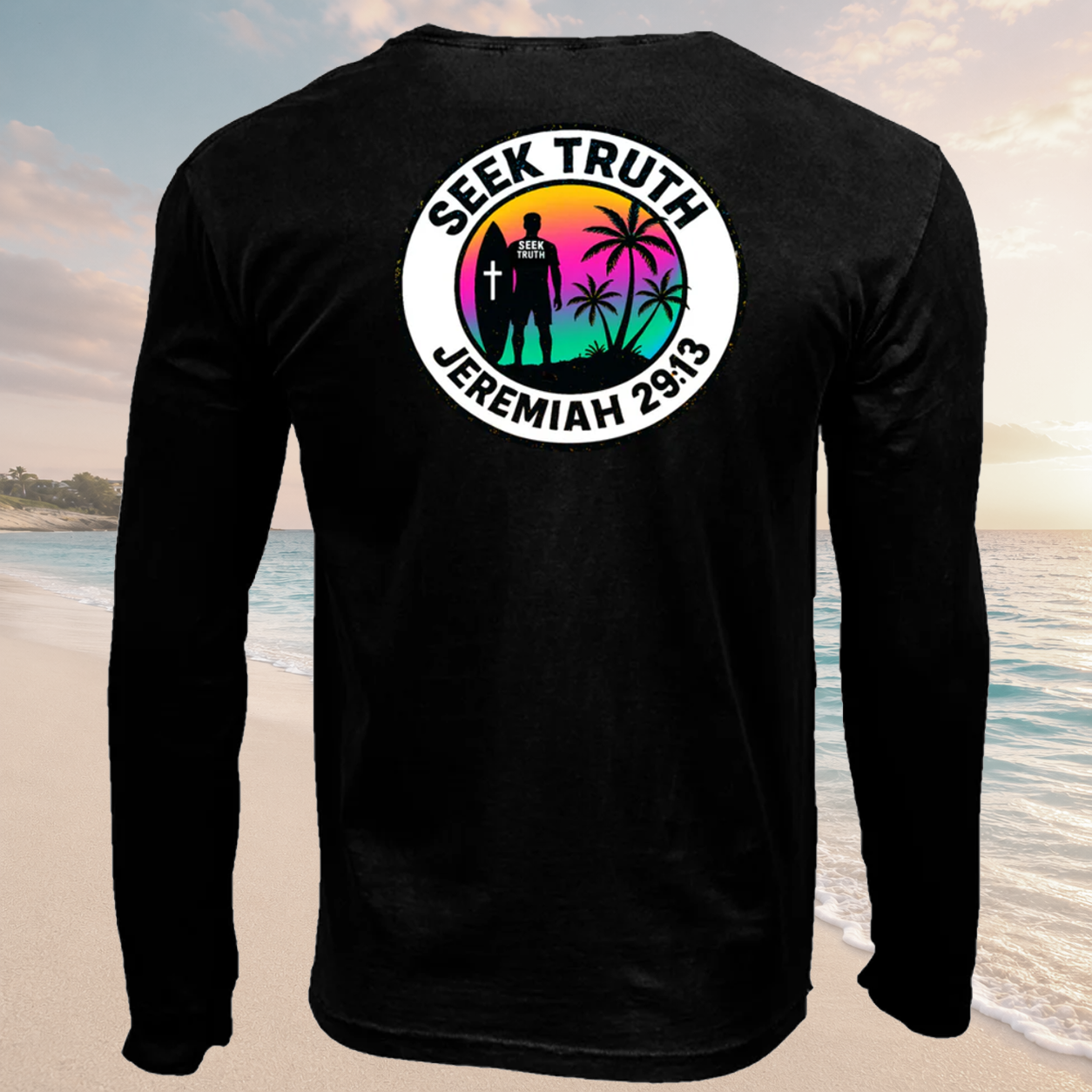 Black long-sleeve shirt with a colorful graphic and text on the beach.