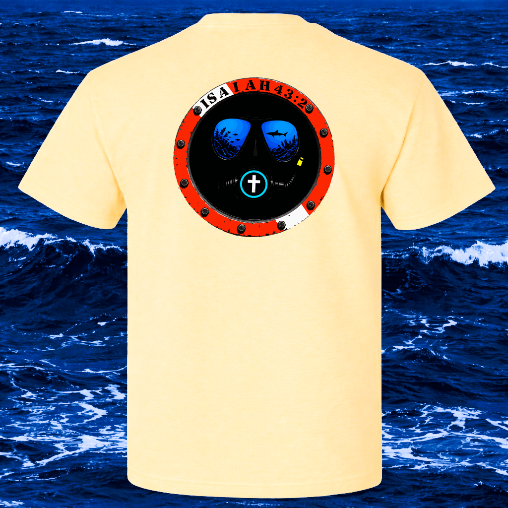 A pale yellow t-shirt shown from the back, featuring a circular graphic print of a life preserver seal with blue water, shark silhouettes, and red text. The background is a digital ocean scene.